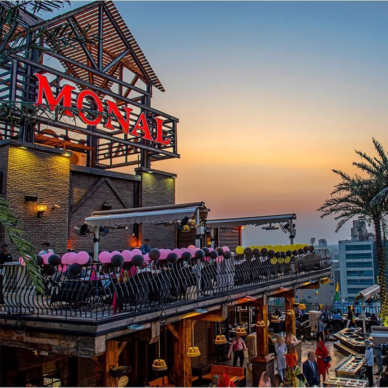 The Monal restaurant terrace lit up at sunset