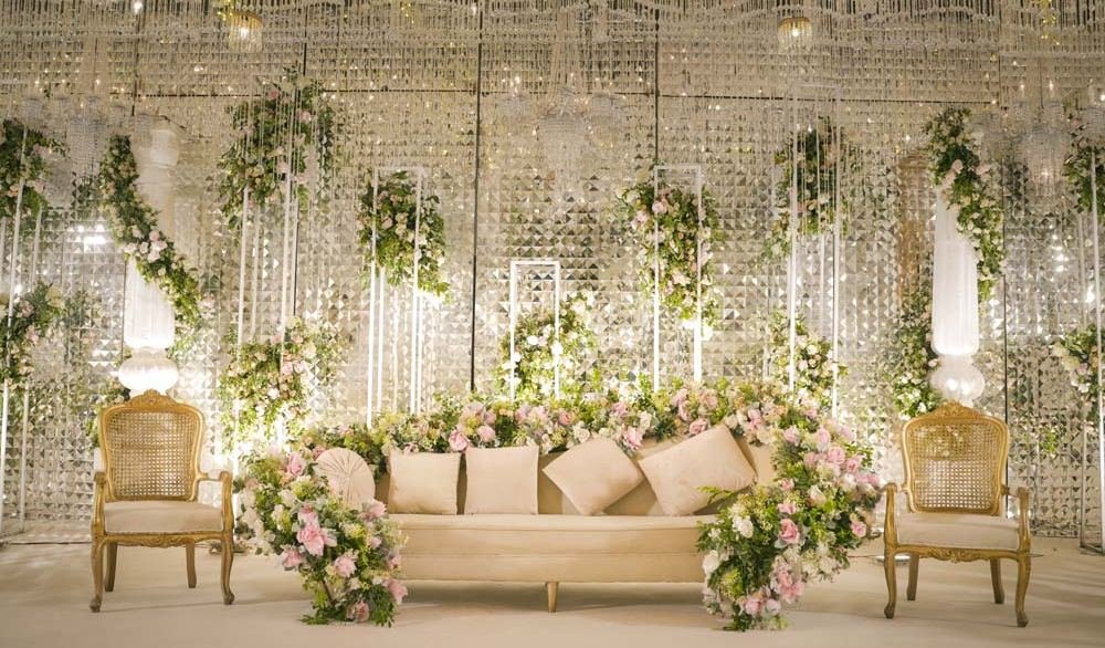 A white floral stage at a Monal Marquee event