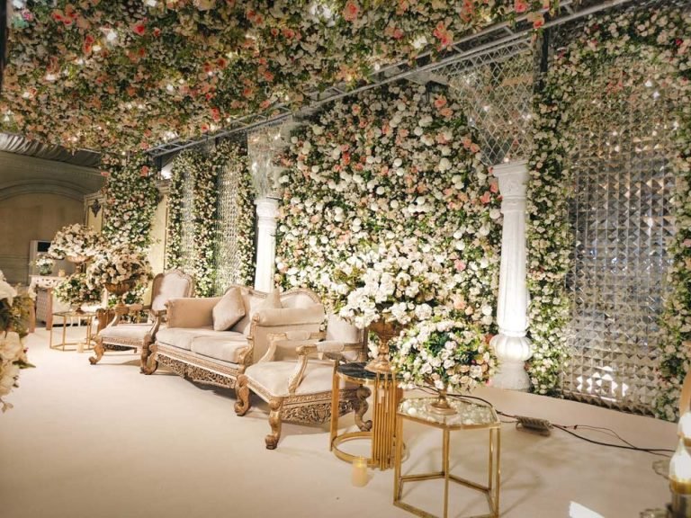 A floral stage and lounge at a Monal Marquee celebration