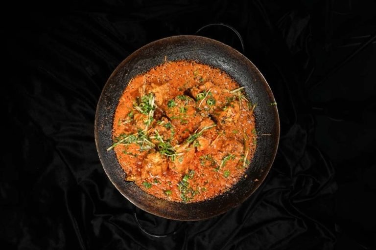 A Monal karahi served in a copper pan