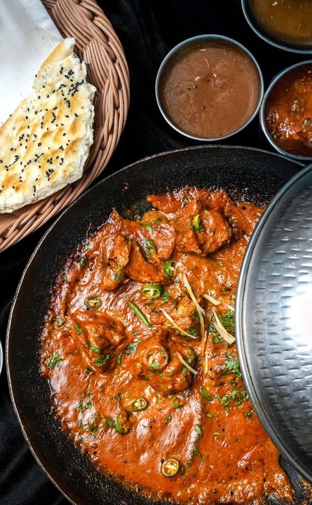 Chicken karahi with naan and chutneys at The Monal